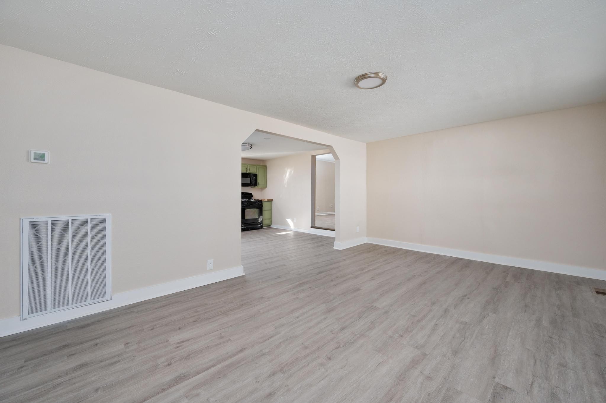621 Halltown Road Portland, TN 37148 - Photo 4 of 23 a view of an empty room with wooden floor and a window