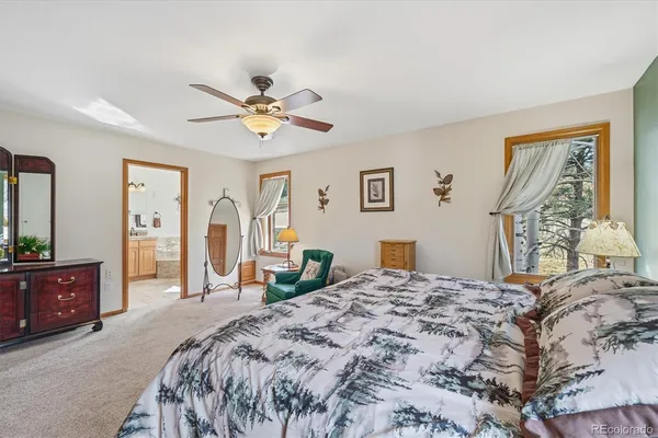 a bedroom with a large bed and a chandelier