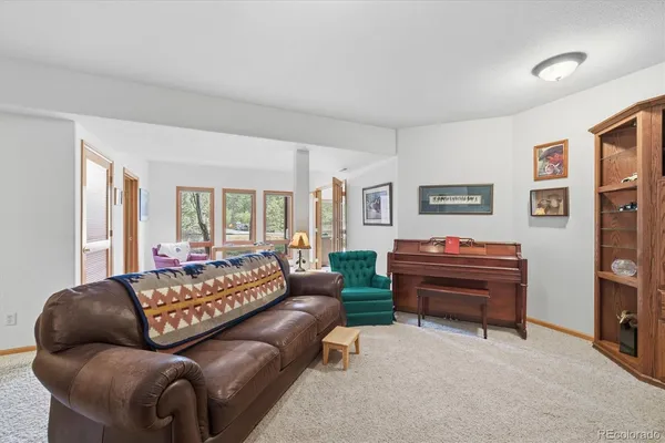 a living room with furniture and a piano
