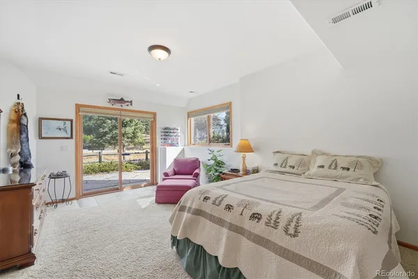 a bedroom with two beds and large window