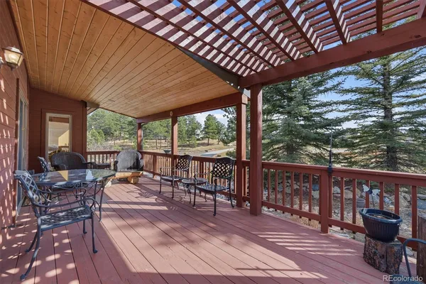a balcony with furniture and wooden floor