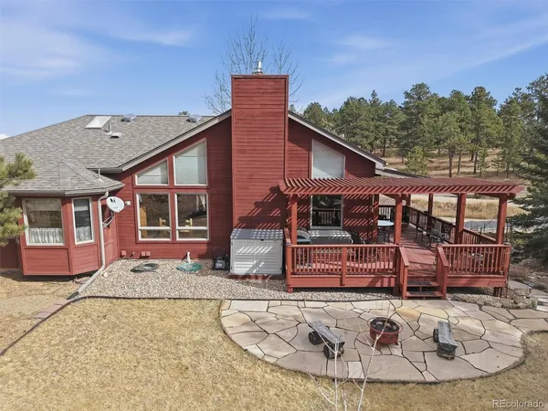 a view of a house with a chairs in patio