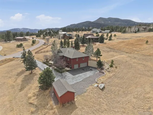 a view of a house with a yard and large tree