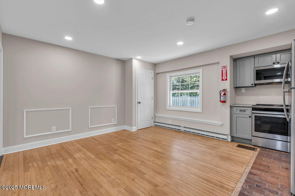 609 Higgins Avenue, Unit 3 Brielle, NJ 08730 - Photo 11 of 25 a view of an empty room with a window and a kitchen