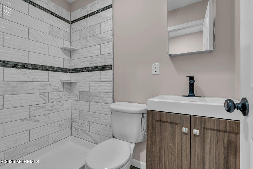 609 Higgins Avenue, Unit 3 Brielle, NJ 08730 - Photo 14 of 25 a bathroom with a sink a toilet and shower