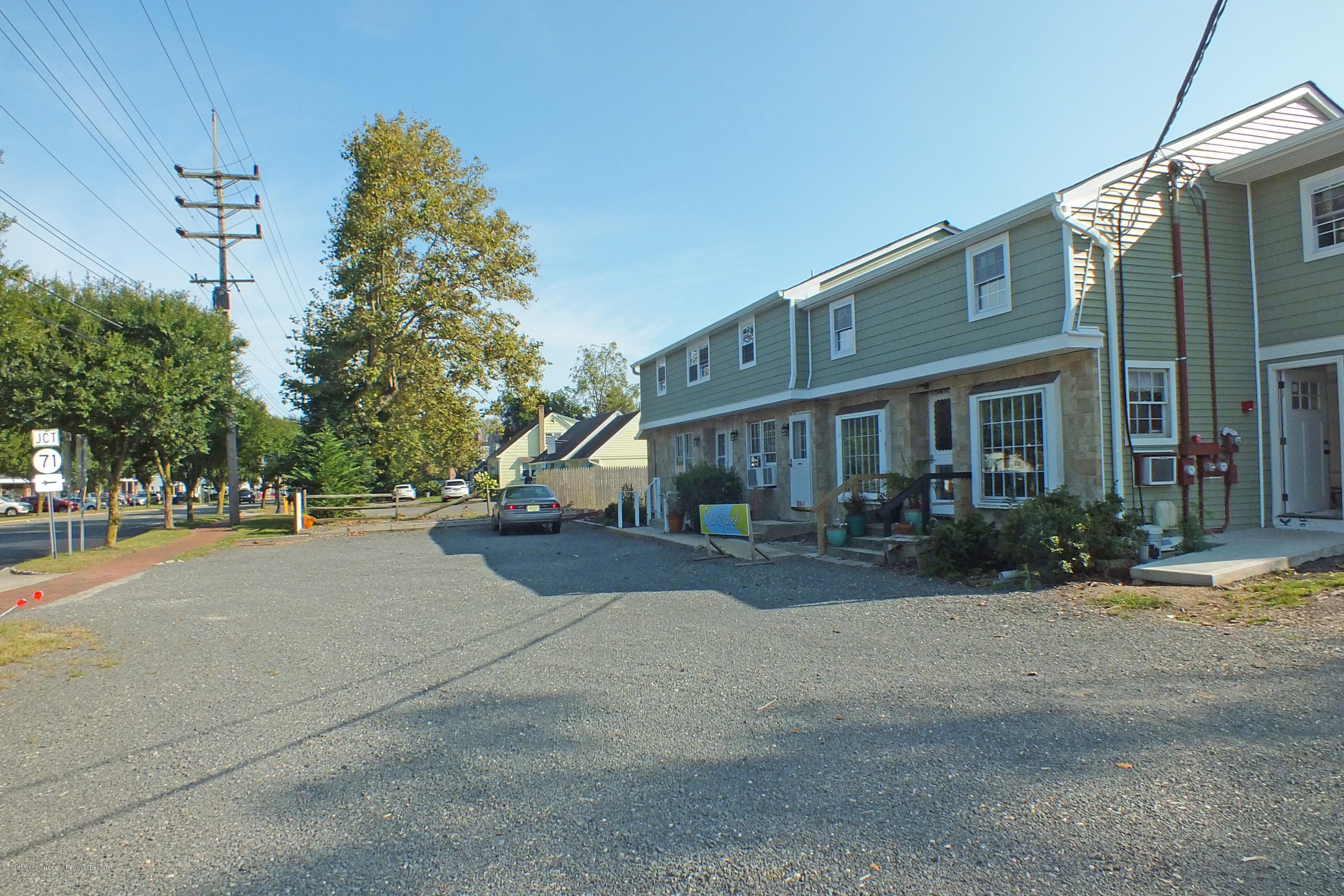 609 Higgins Avenue, Unit 3 Brielle, NJ 08730 - Photo 2 of 25 a front view of a house with a yard and garage