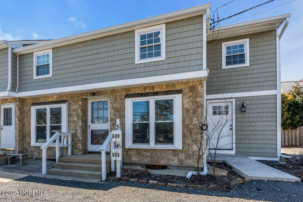 609 Higgins Avenue, Unit 3 Brielle, NJ 08730 - Photo 3 of 25 a front view of a house with a floor to ceiling windows