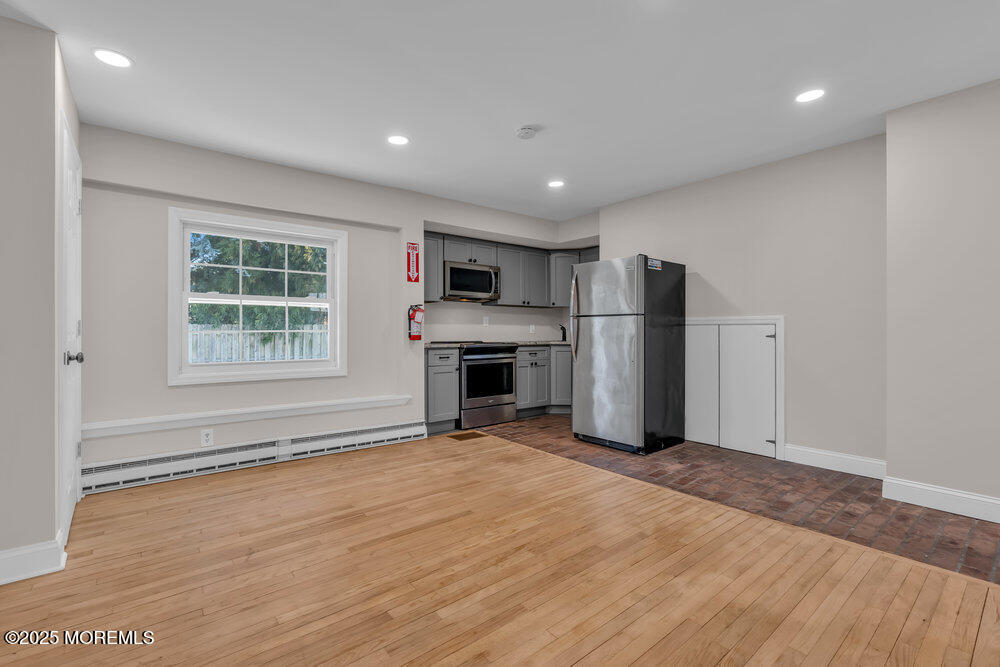 609 Higgins Avenue, Unit 3 Brielle, NJ 08730 - Photo 8 of 25 a view of a kitchen with a fridge and a window