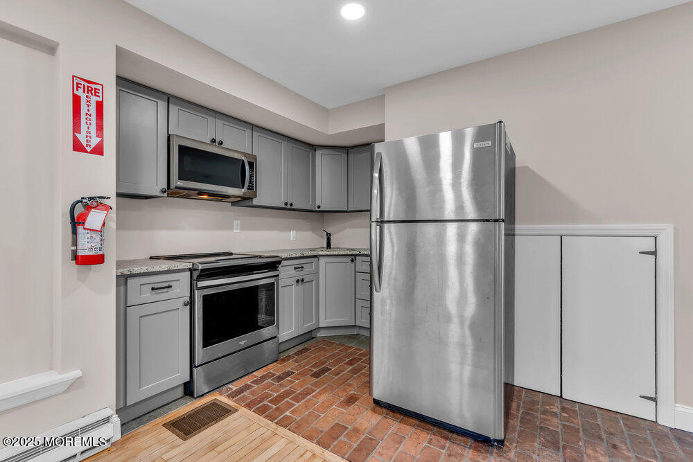 609 Higgins Avenue, Unit 3 Brielle, NJ 08730 - Photo 9 of 25 a kitchen with a refrigerator stove and microwave