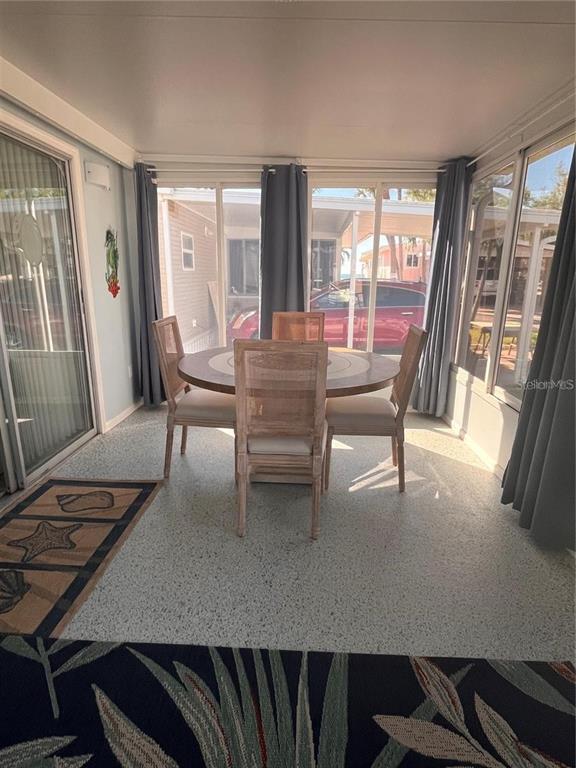 2295 North Beach Road, Unit 23 Englewood, FL 34223 - Photo 5 of 19 a dining room with furniture and wooden floor