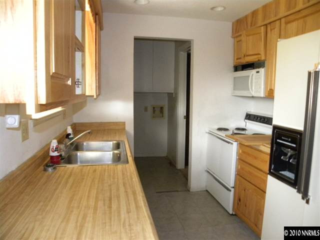 14030 Perlite Drive Reno, NV 89521 - Photo 4 of 8 a bedroom with a bed and wooden floor