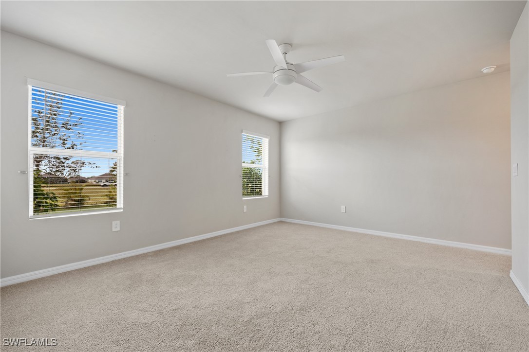16039 Quinta Drive Punta Gorda, FL 33955 - Photo 18 of 48 an empty room with windows and fan