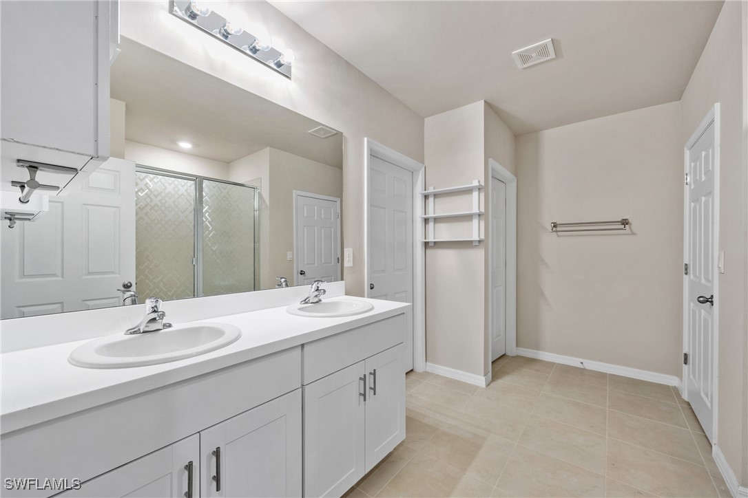 16039 Quinta Drive Punta Gorda, FL 33955 - Photo 19 of 48 a bathroom with a double vanity sink and mirror