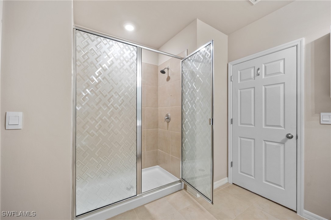 16039 Quinta Drive Punta Gorda, FL 33955 - Photo 20 of 48 a bathroom with a glass shower door