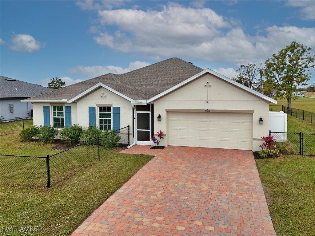 16039 Quinta Drive Punta Gorda, FL 33955 - Photo 34 of 48 a front view of a house with a yard and garage