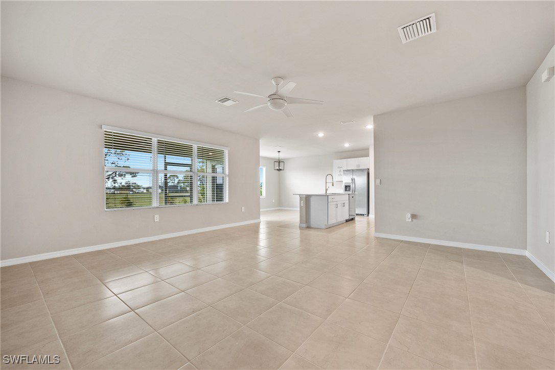 16039 Quinta Drive Punta Gorda, FL 33955 - Photo 7 of 48 a view of an empty room with a window and a kitchen view