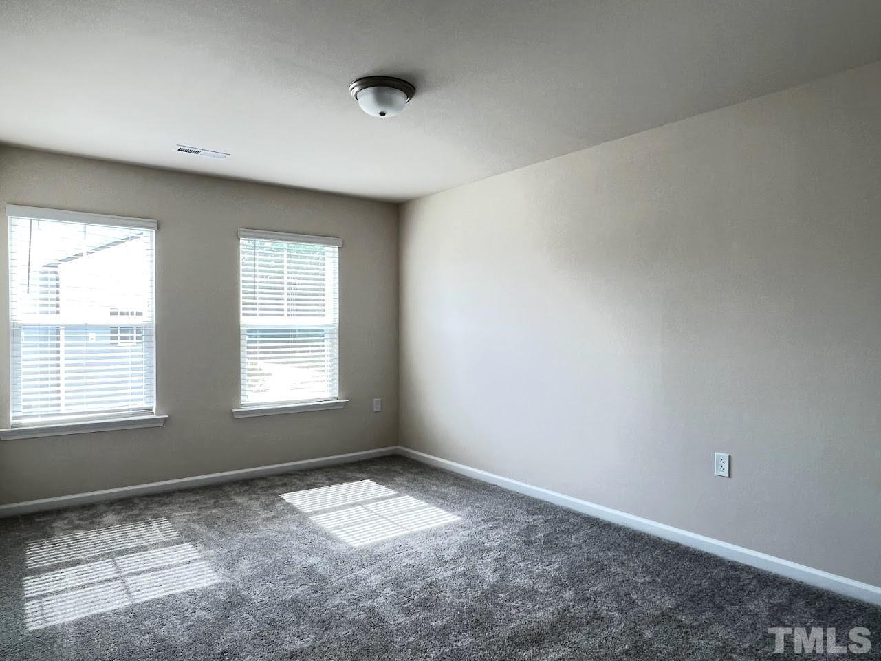 4812 Trikala Avenue Raleigh, NC 27603 - Photo 11 of 16 an empty room with a empty space and windows