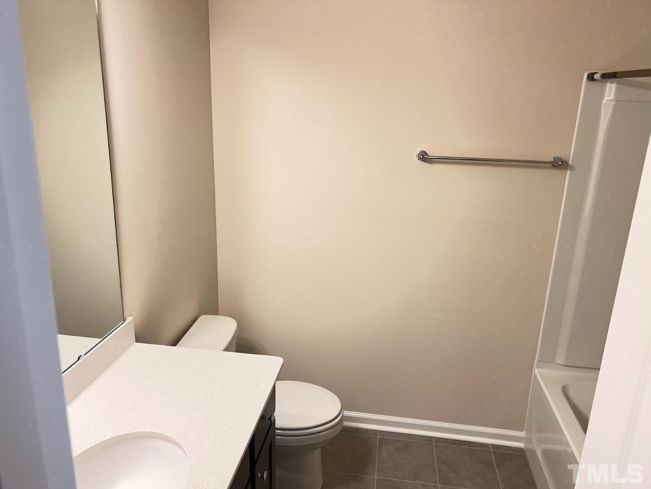 4812 Trikala Avenue Raleigh, NC 27603 - Photo 13 of 16 a white toilet sitting next to a shower