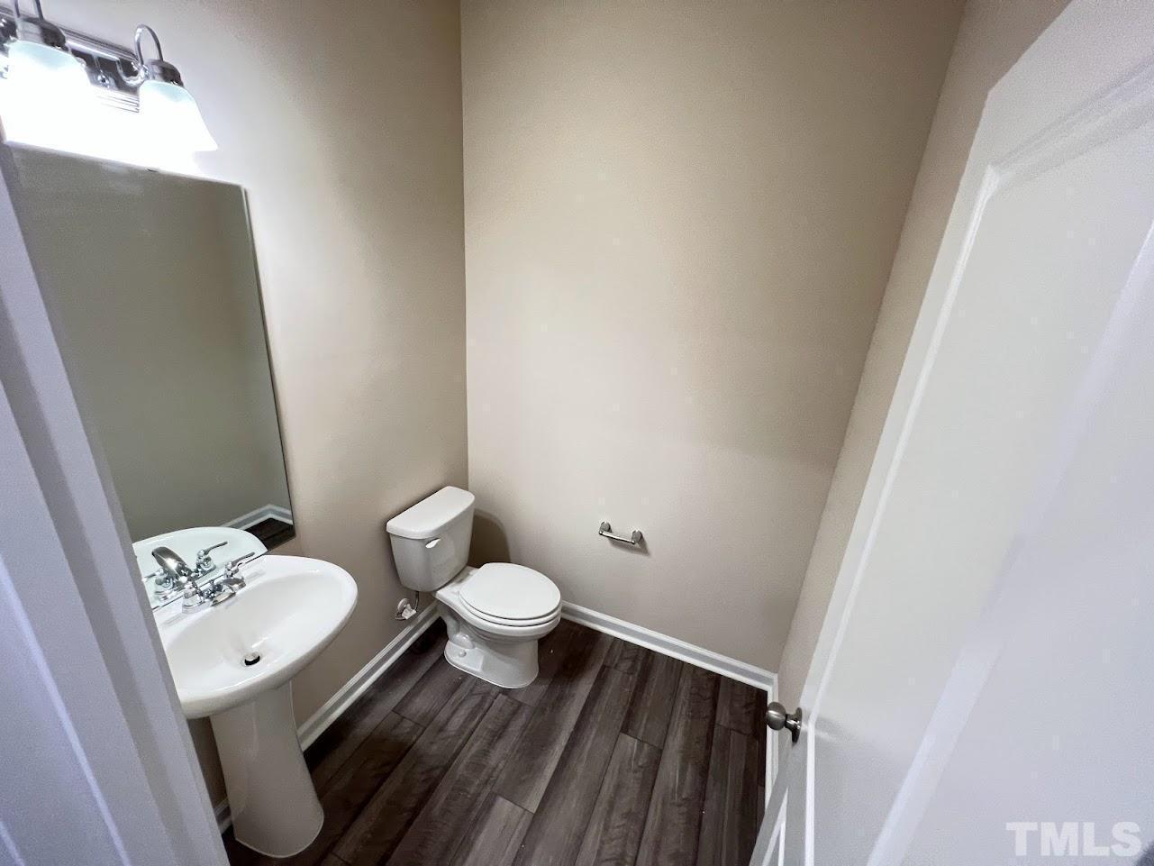 4812 Trikala Avenue Raleigh, NC 27603 - Photo 8 of 16 a bathroom with a granite countertop toilet and sink