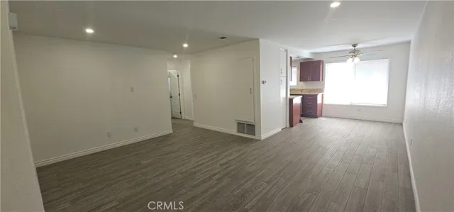 a view of a room with wooden floor and window