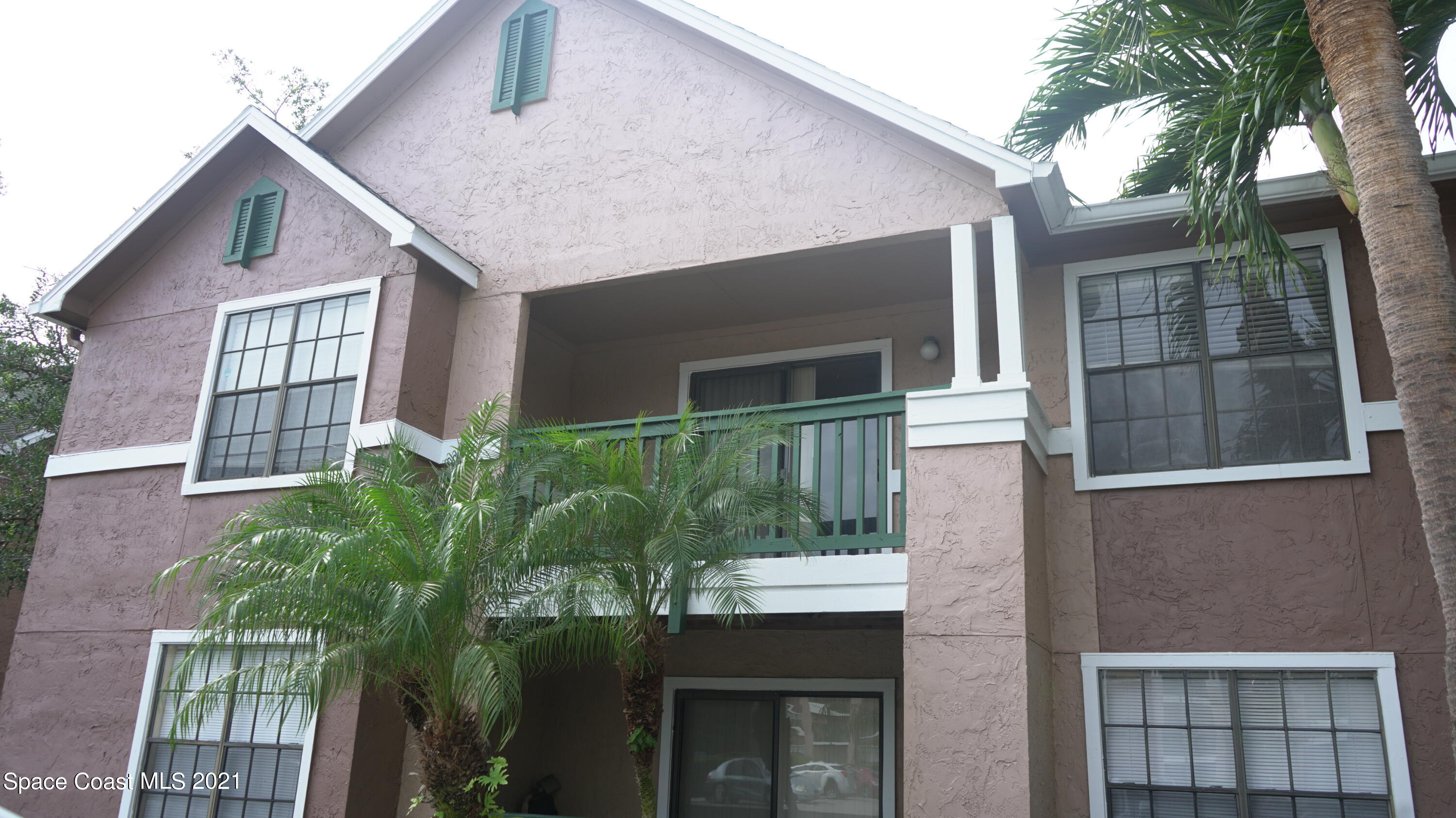 7667 North Wickham Road, Unit 1309 Melbourne, FL 32940 - Photo 1 of 18 a front view of a house with a yard