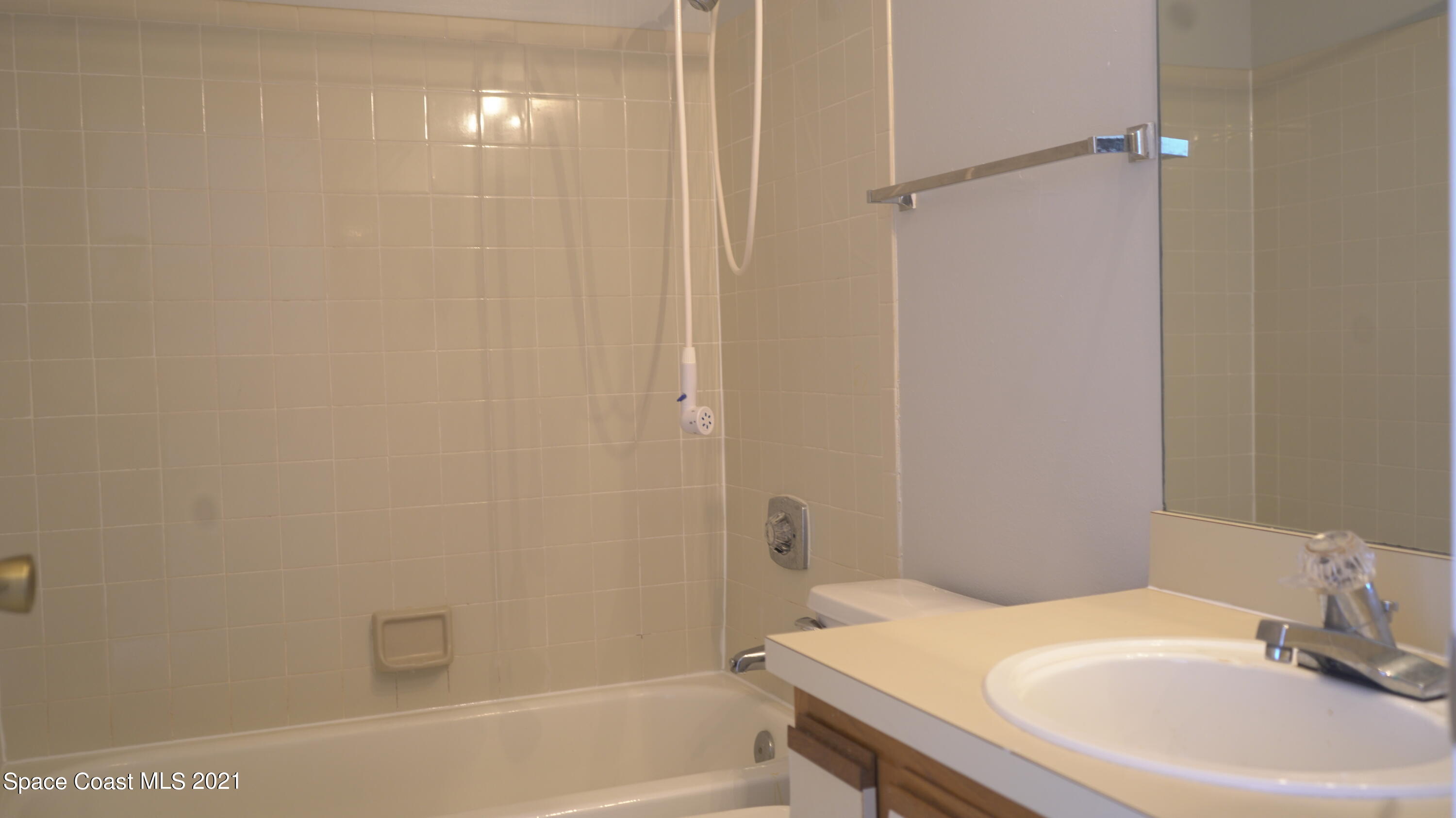 7667 North Wickham Road, Unit 1309 Melbourne, FL 32940 - Photo 17 of 18 a bathroom with a sink a toilet and shower