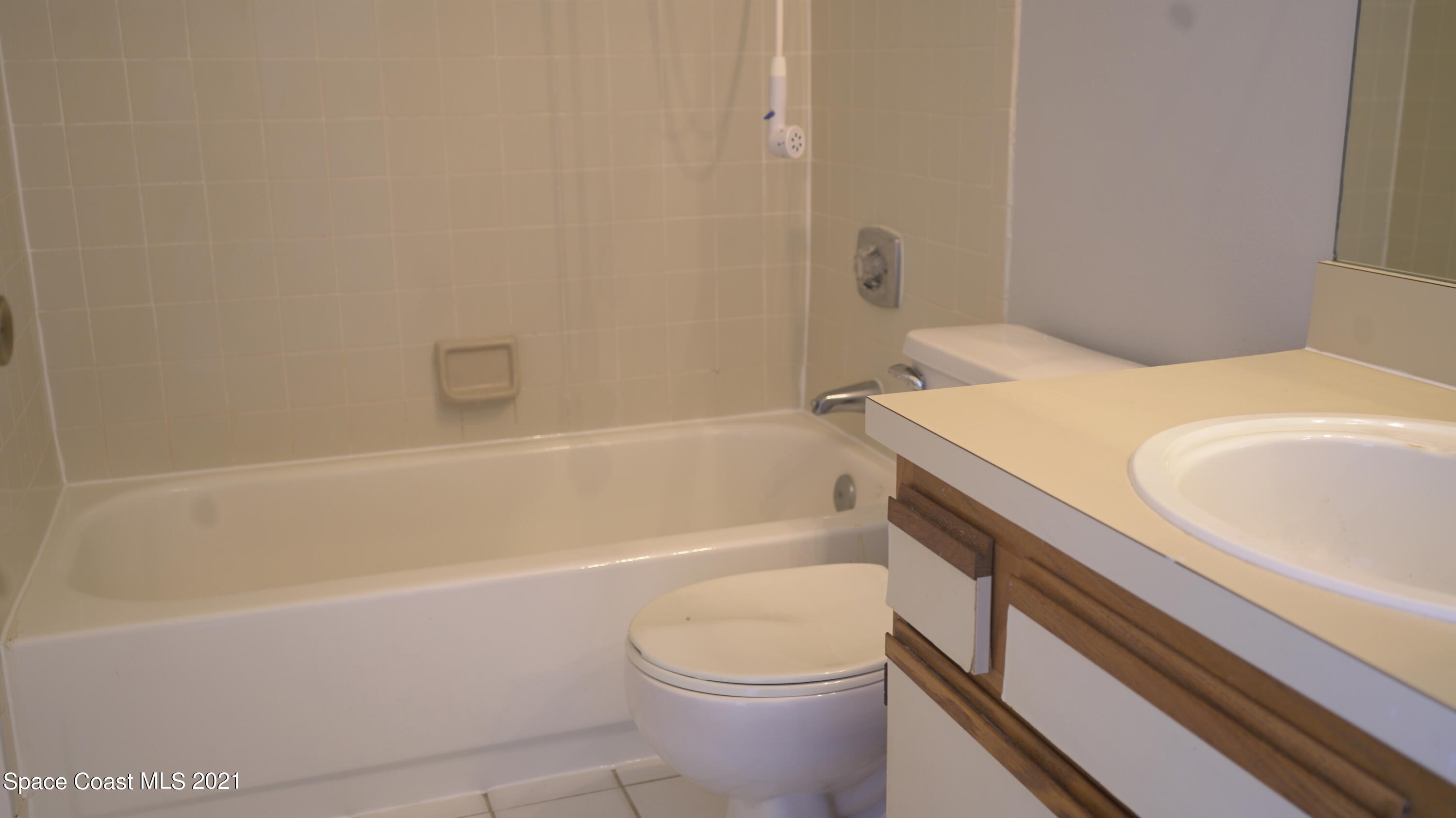 7667 North Wickham Road, Unit 1309 Melbourne, FL 32940 - Photo 18 of 18 a bathroom with a sink a toilet and bathtub