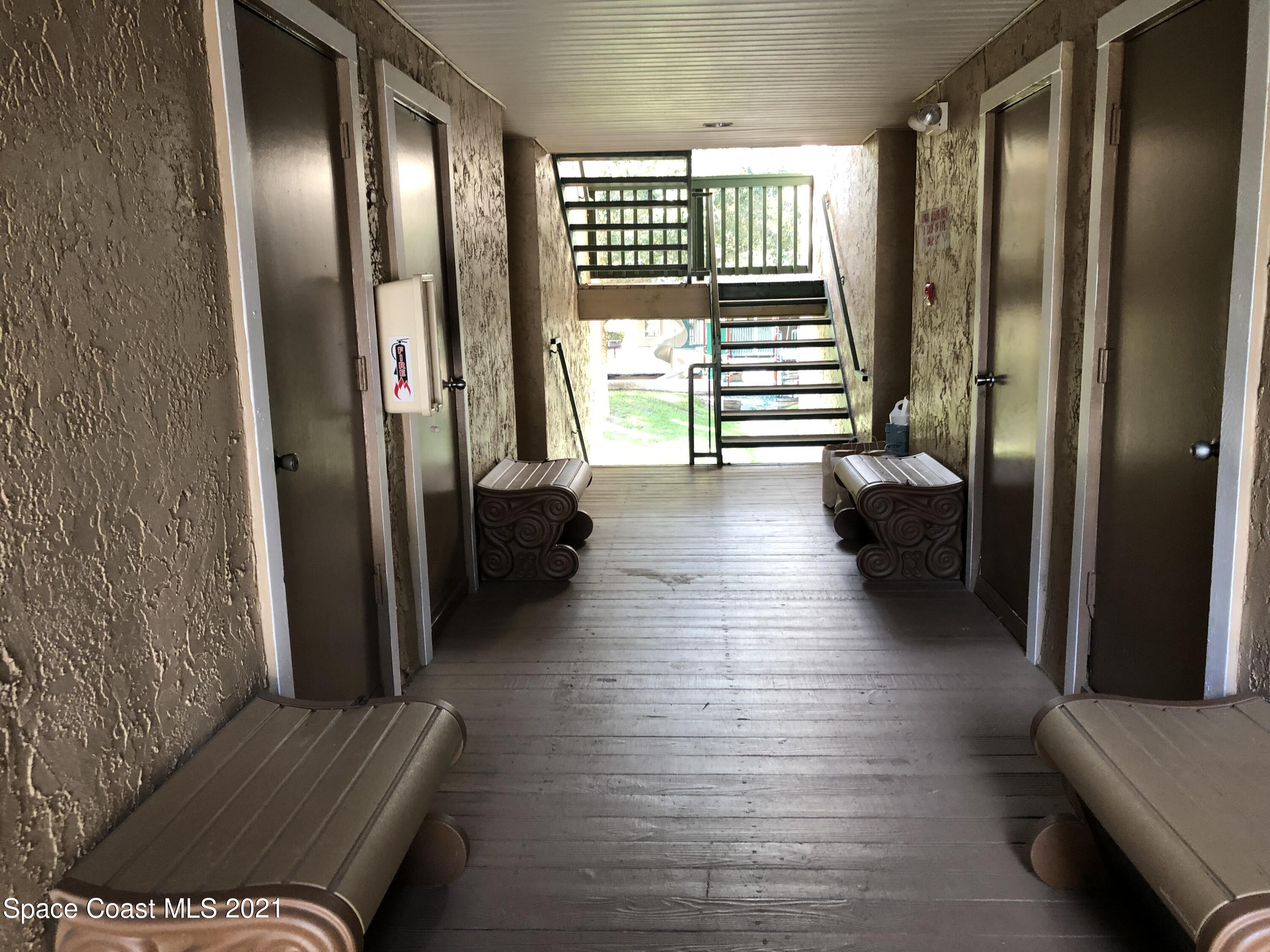 7667 North Wickham Road, Unit 1309 Melbourne, FL 32940 - Photo 5 of 18 a view of hallway with furniture and a large window