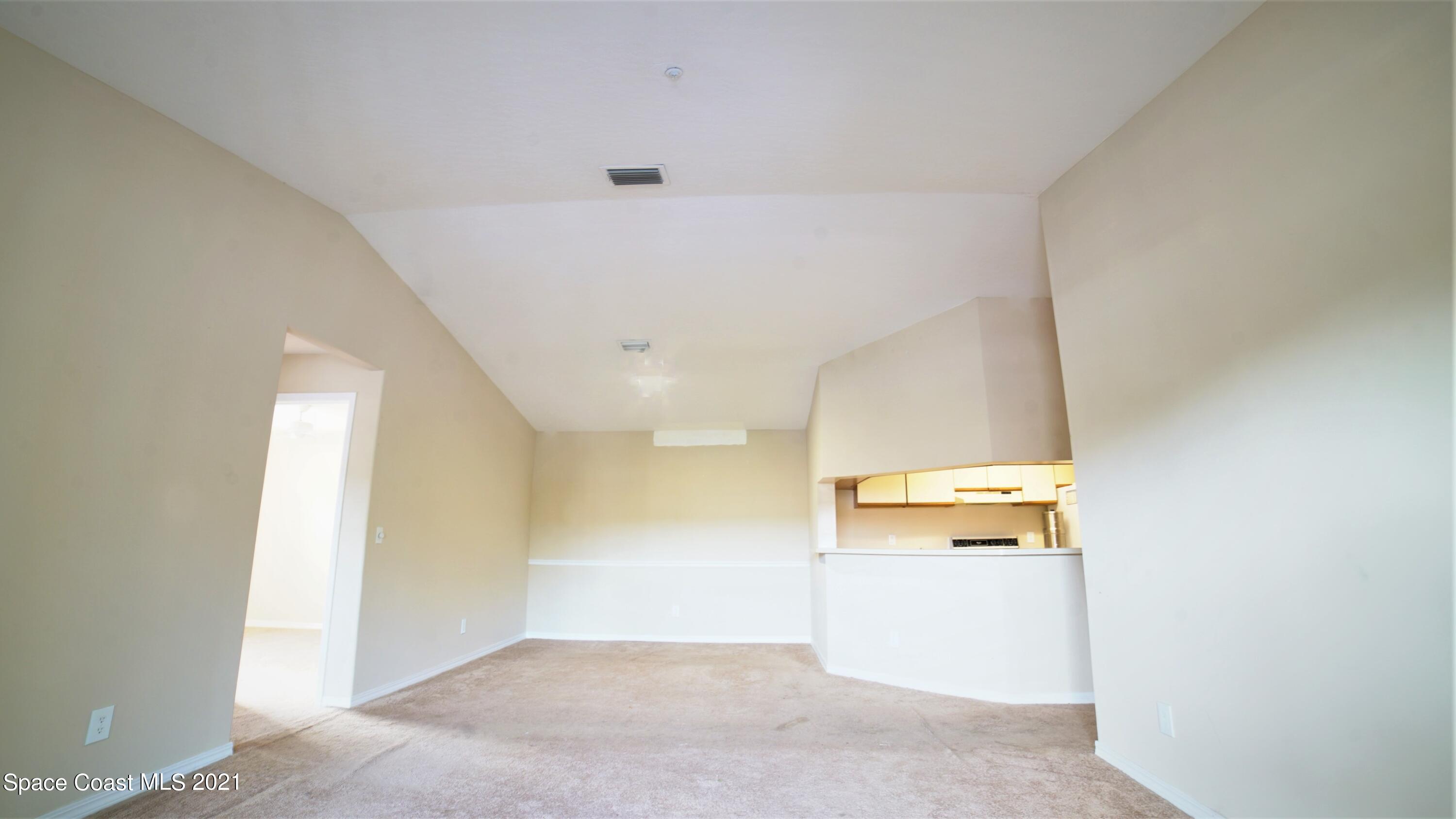 7667 North Wickham Road, Unit 1309 Melbourne, FL 32940 - Photo 8 of 18 a view of a room with a hallway