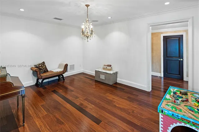 a swimming pool with outdoor seating and a potted plants