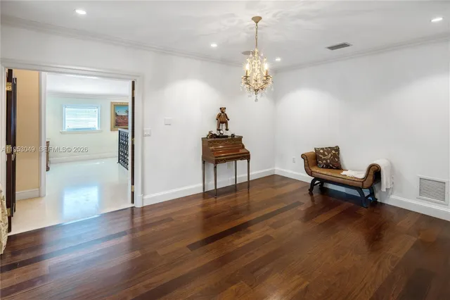 a view of a patio with couches table and chairs potted plants and palm tree