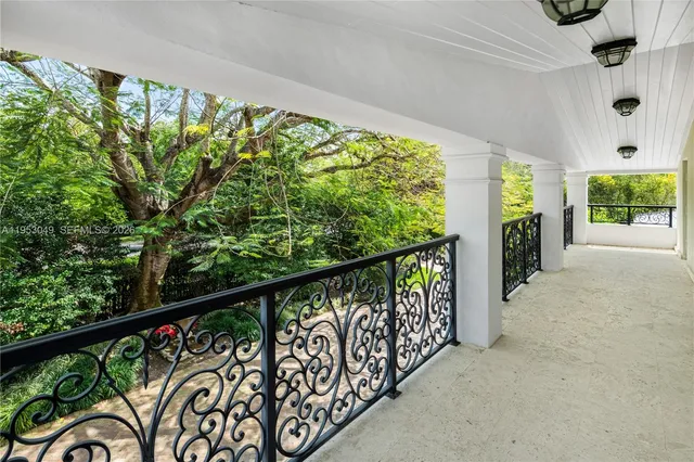 a patio with a table and chairs under an umbrella