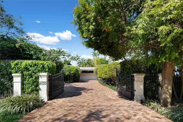 a living room with furniture and large windows