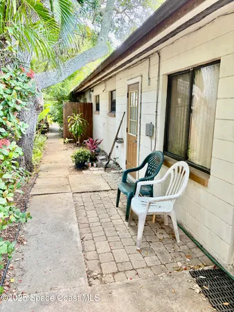 a view of a house with backyard and sitting area