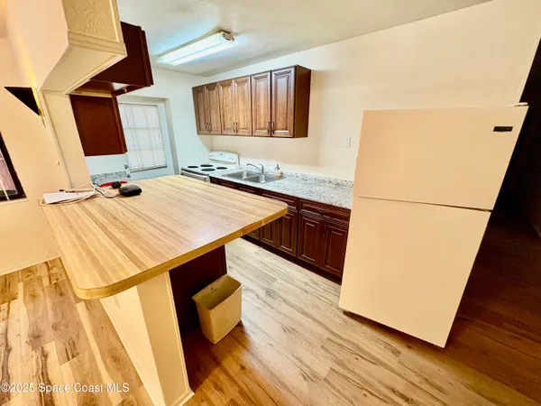 a kitchen with a sink and a refrigerator