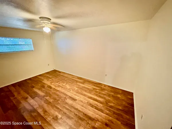 a view of a room with a ceiling fan