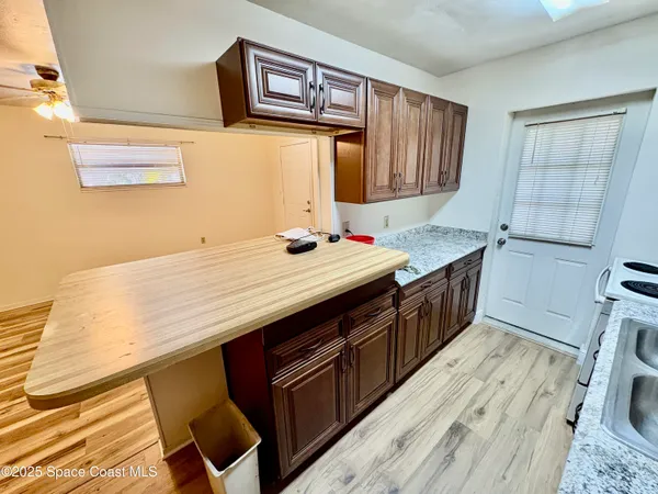 a kitchen with a stove a sink and a refrigerator
