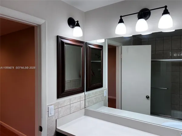 a bathroom with a sink and a mirror