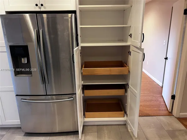 a view of walk in closet with empty racks