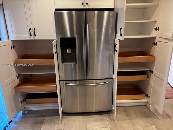 a view of walk in closet with empty racks