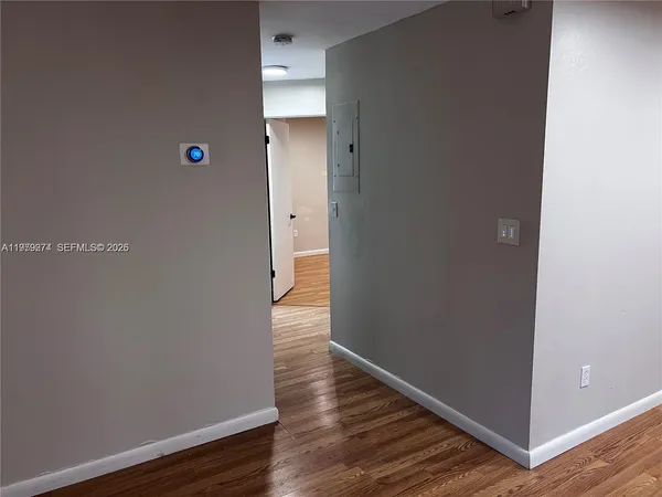 a view of a room with wooden floor