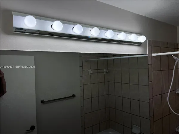a bathroom with a sink a mirror and shower
