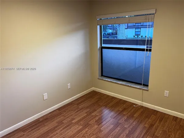a view of a room with wooden floor