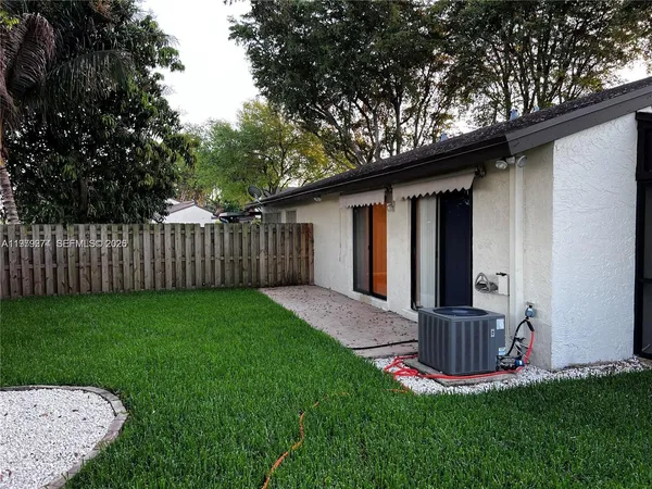 a view of a backyard with wooden fence