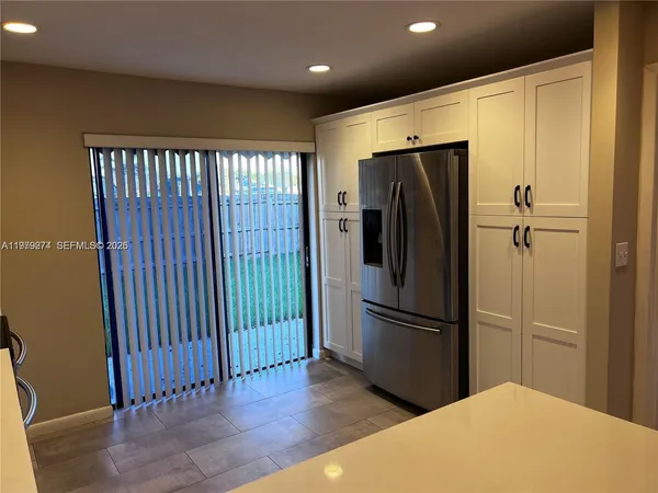a view of a refrigerator in kitchen and wooden floor
