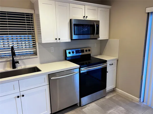 a kitchen with a stove and a microwave