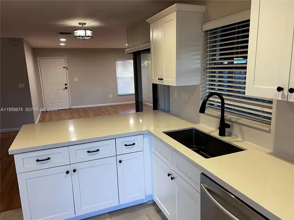 a kitchen with a sink and cabinets
