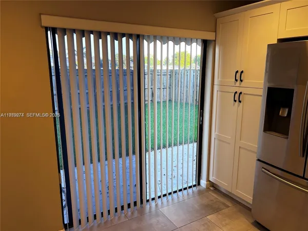 a view of a utility room with a door and a window