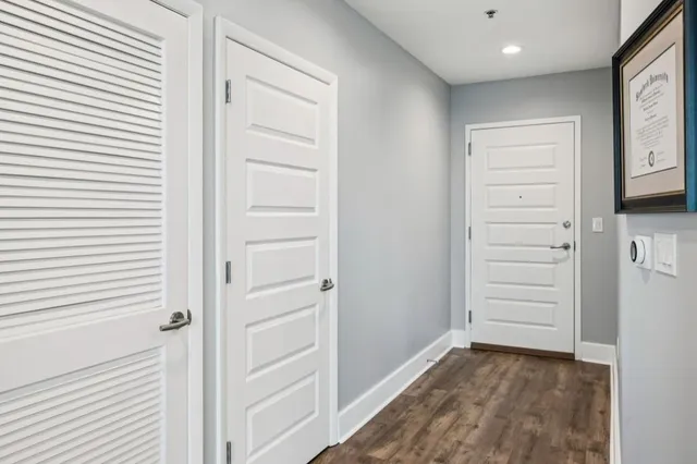 a kitchen with a refrigerator and a flat screen tv