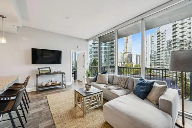 a living room with furniture kitchen and a table